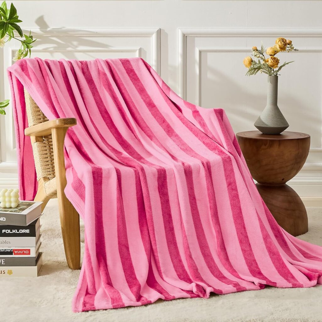 striped pink throw blanket draped over armchair