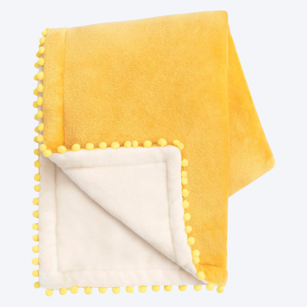 mustard yellow velvet throw blanket with pom pom edging
